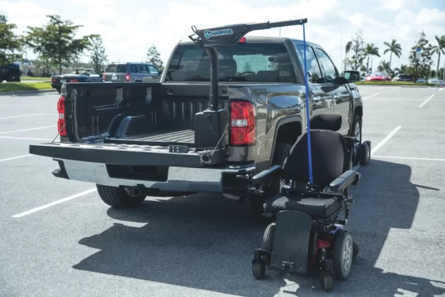 Hoist/Boom A boom lift ready to lift a mobility scooter into the back of a pickup truck.