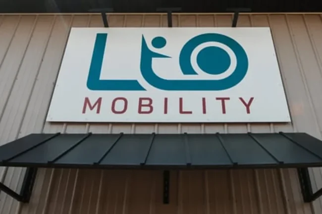 The LIO Mobility Logo hanging above the main entrance of their building.