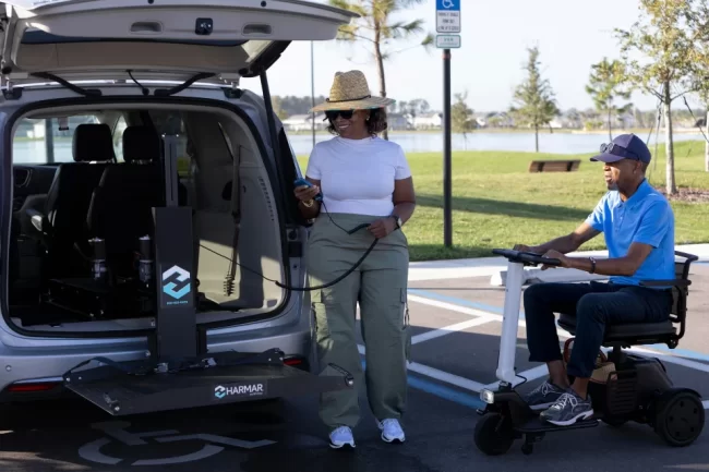 Hybrid_Lift_3-aspect-ratio-960-640 A man sits in his mobility scooter as his wife prepares to assist with a hybrid lift.