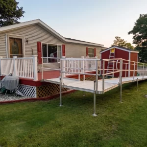 A long, L-shaped wheelchair ramp leading to the back deck of a home.