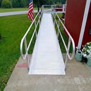 This is a picture of a wheelchair ramp leading from the driveway of a home.