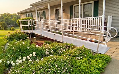 An L-shaped wheelchair ramp installed on the front of a home.