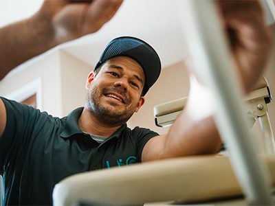 A LIO Mobility service technician working to repair a stairlift in someone's home.