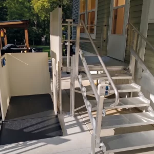 A vertical platform lift installed at a home's front entrance.