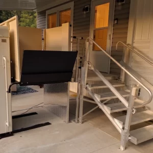 A vertical platform lift installed at the front deck of a house.